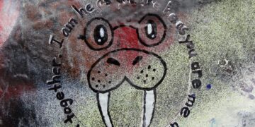 A walrus with lyrics from The Beatles' I am the Walrus written around it