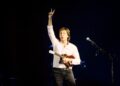 Sir Paul McCartney of The Beatles on stage with a ukelele
