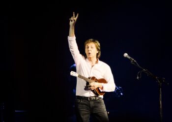 Sir Paul McCartney of The Beatles on stage with a ukelele